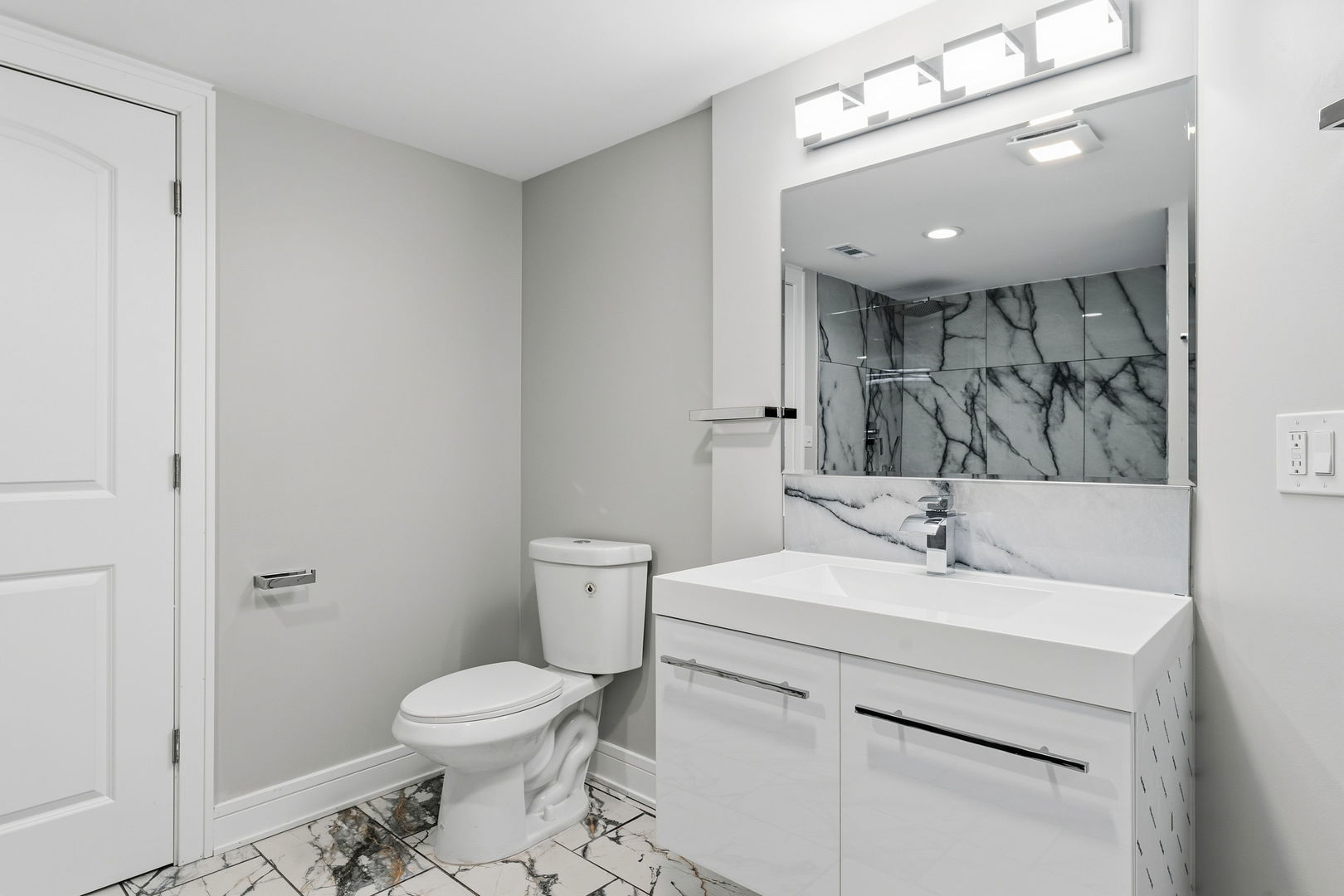 9410 South Champlain Avenue Chicago, IL 60619 - Photo 19 of 35 a bathroom with a toilet sink and mirror