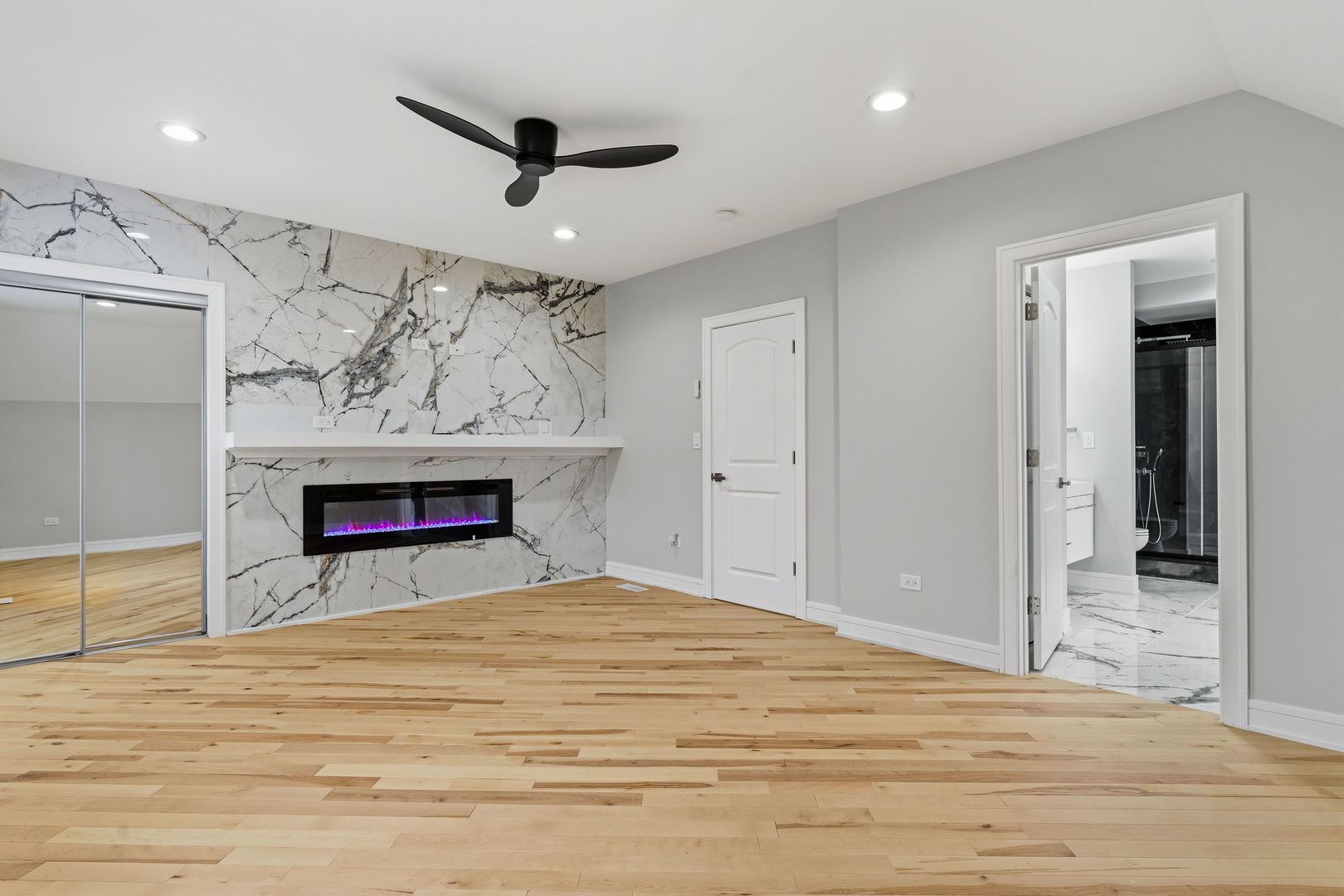 9410 South Champlain Avenue Chicago, IL 60619 - Photo 27 of 35 a bed room with a fireplace and a ceiling fan