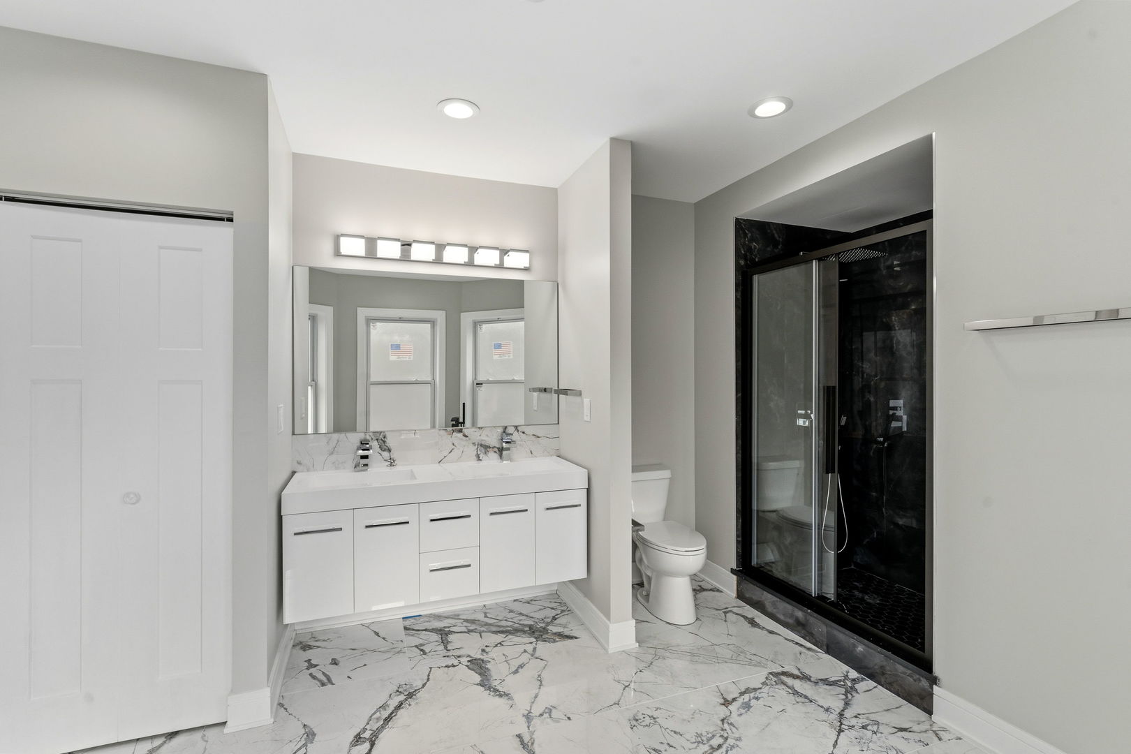 9410 South Champlain Avenue Chicago, IL 60619 - Photo 29 of 35 a spacious bathroom with a double vanity sink a mirror and a bathtub