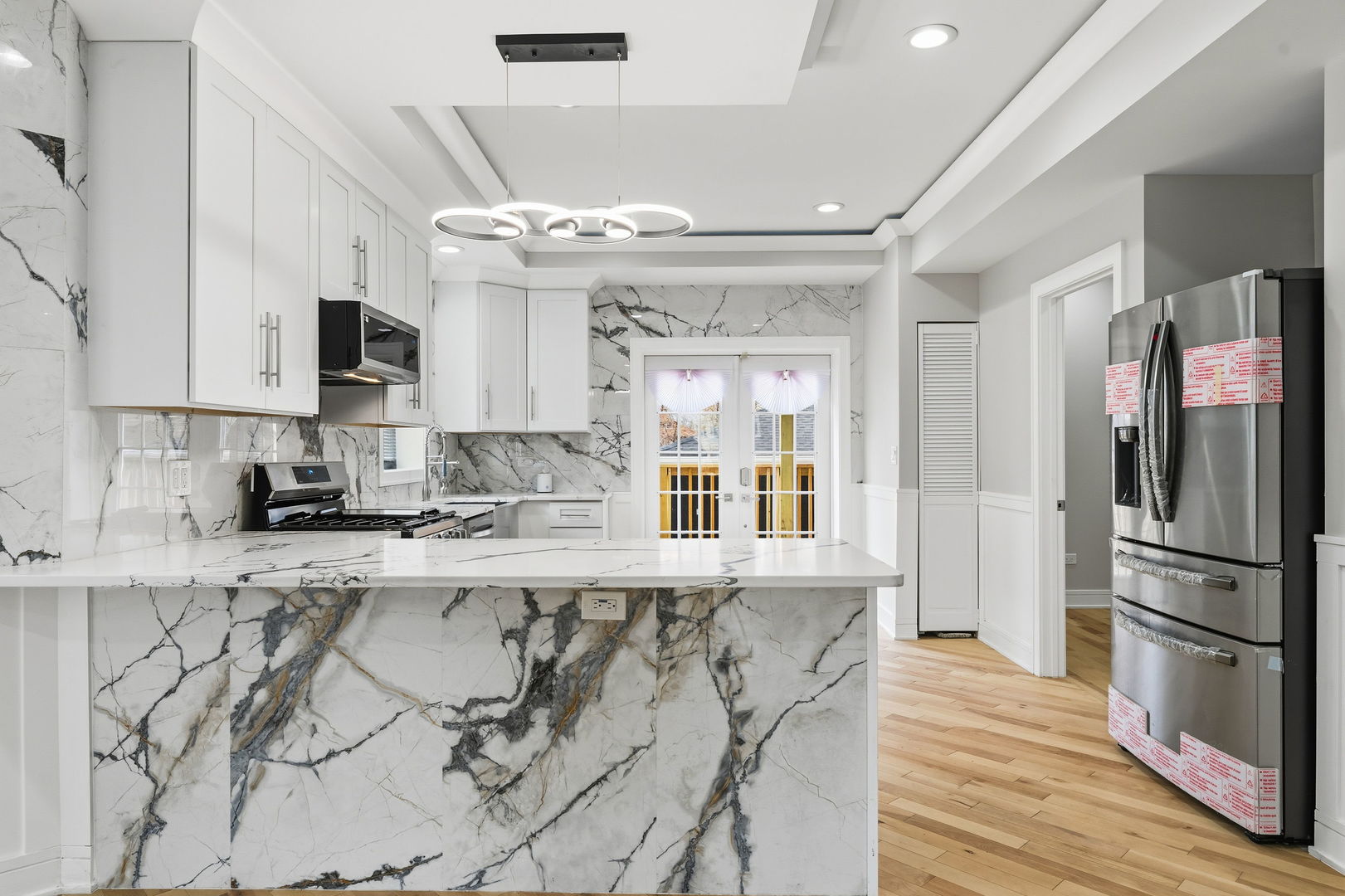 9410 South Champlain Avenue Chicago, IL 60619 - Photo 7 of 35 a kitchen with granite countertop a refrigerator and wooden cabinets