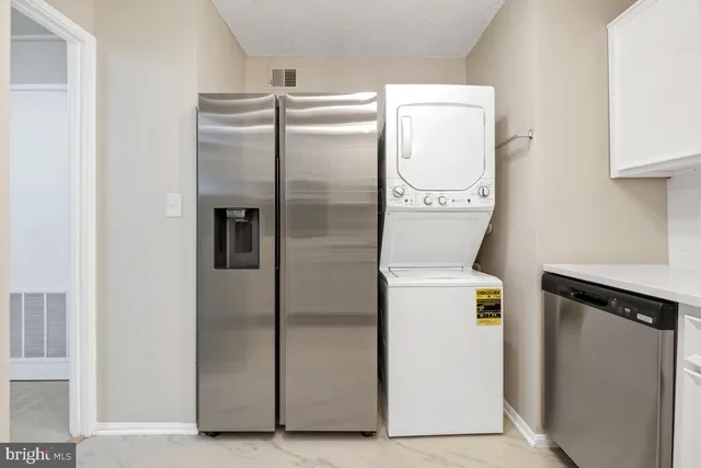 a white house with a big yard and large trees