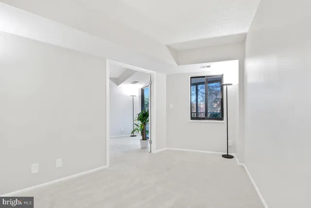 a living room with fireplace furniture and a floor to ceiling window