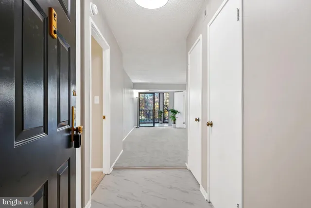 a view of a hallway with wooden floor