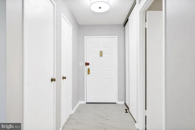 an empty room with closet and a window