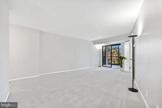 an empty room with windows and entrance