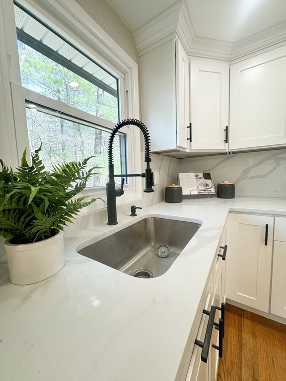 12 Evelyn Road Beverly, MA 01915 - Photo 11 of 37 a kitchen with a sink a counter and a potted plant