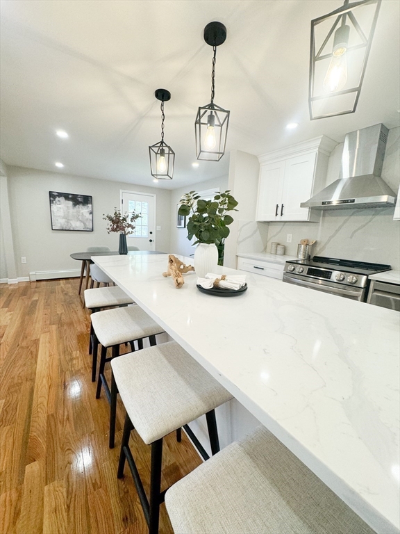 12 Evelyn Road Beverly, MA 01915 - Photo 13 of 37 a kitchen with a table chairs and wooden floor