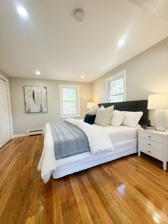 12 Evelyn Road Beverly, MA 01915 - Photo 19 of 37 a spacious bedroom with a large bed and a chandelier