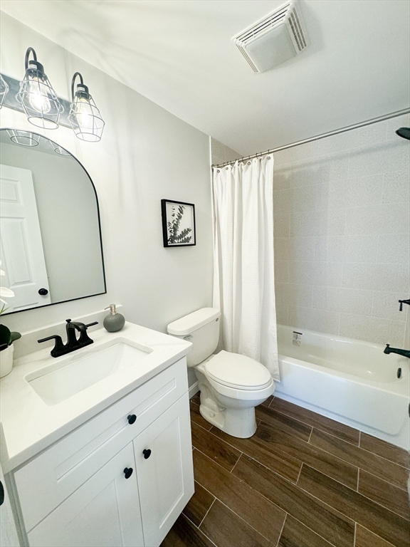 12 Evelyn Road Beverly, MA 01915 - Photo 21 of 37 a bathroom with a sink toilet a mirror and shower