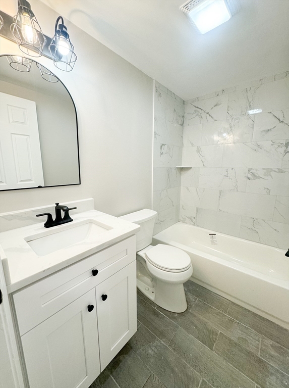 12 Evelyn Road Beverly, MA 01915 - Photo 28 of 37 a bathroom with a toilet a sink a tub and a mirror