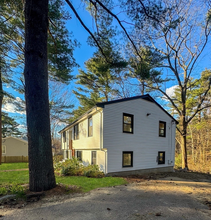 12 Evelyn Road Beverly, MA 01915 - Photo 3 of 37 a front view of a house with a yard and garage