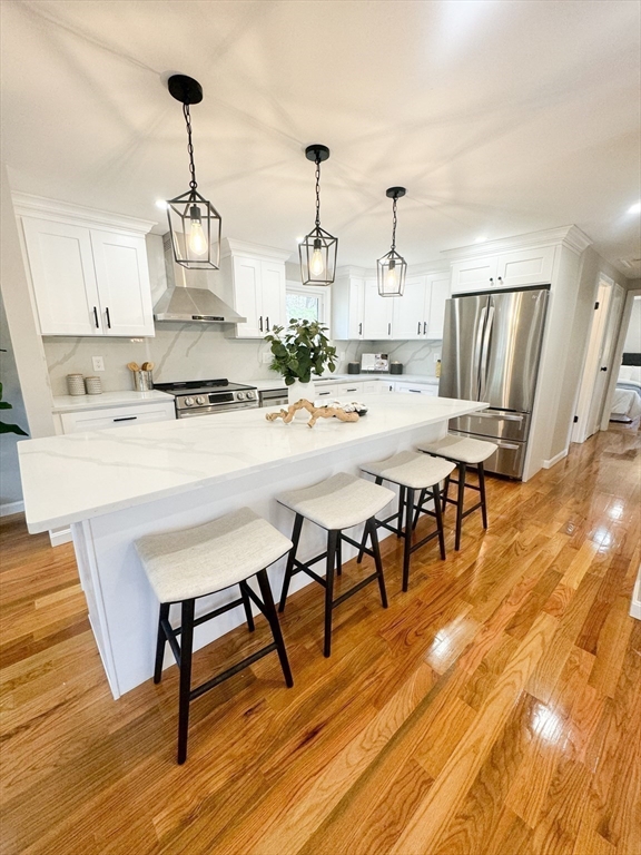 12 Evelyn Road Beverly, MA 01915 - Photo 6 of 37 a view of a dining room with furniture and wooden floor