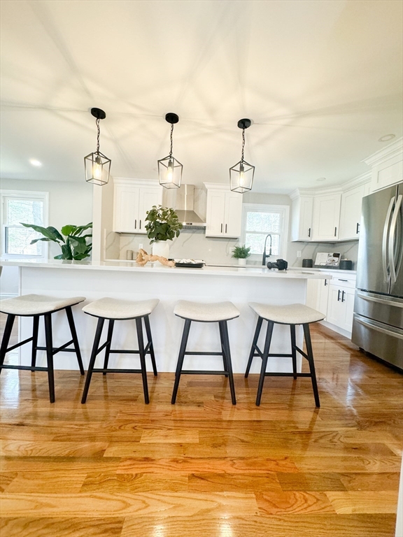 12 Evelyn Road Beverly, MA 01915 - Photo 7 of 37 a room with stainless steel appliances kitchen island granite countertop a table chairs in it and white cabinets