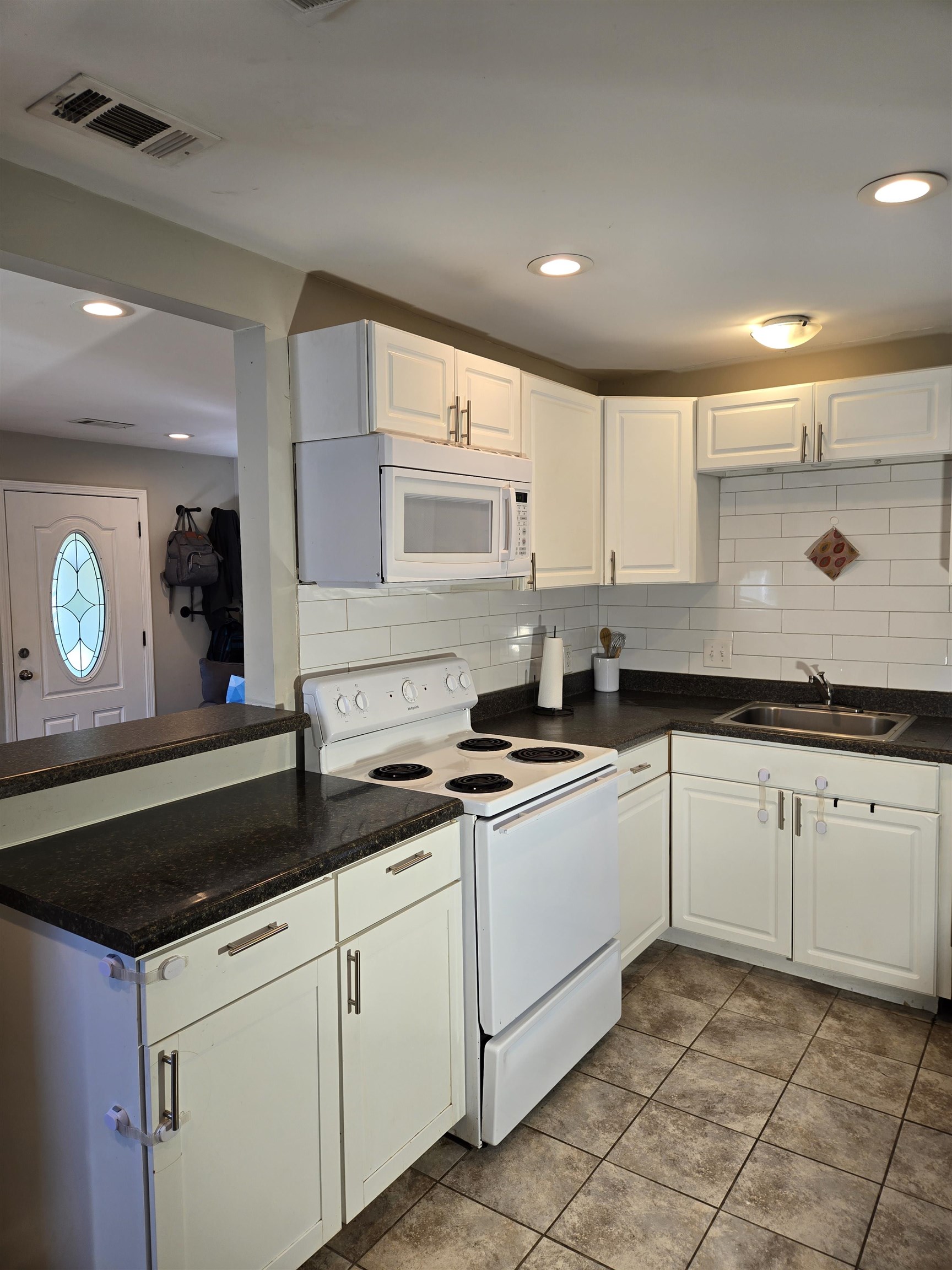 5475 Mesquite Road Memphis, TN 38120 - Photo 7 of 23 a kitchen with granite countertop white cabinets and a sink