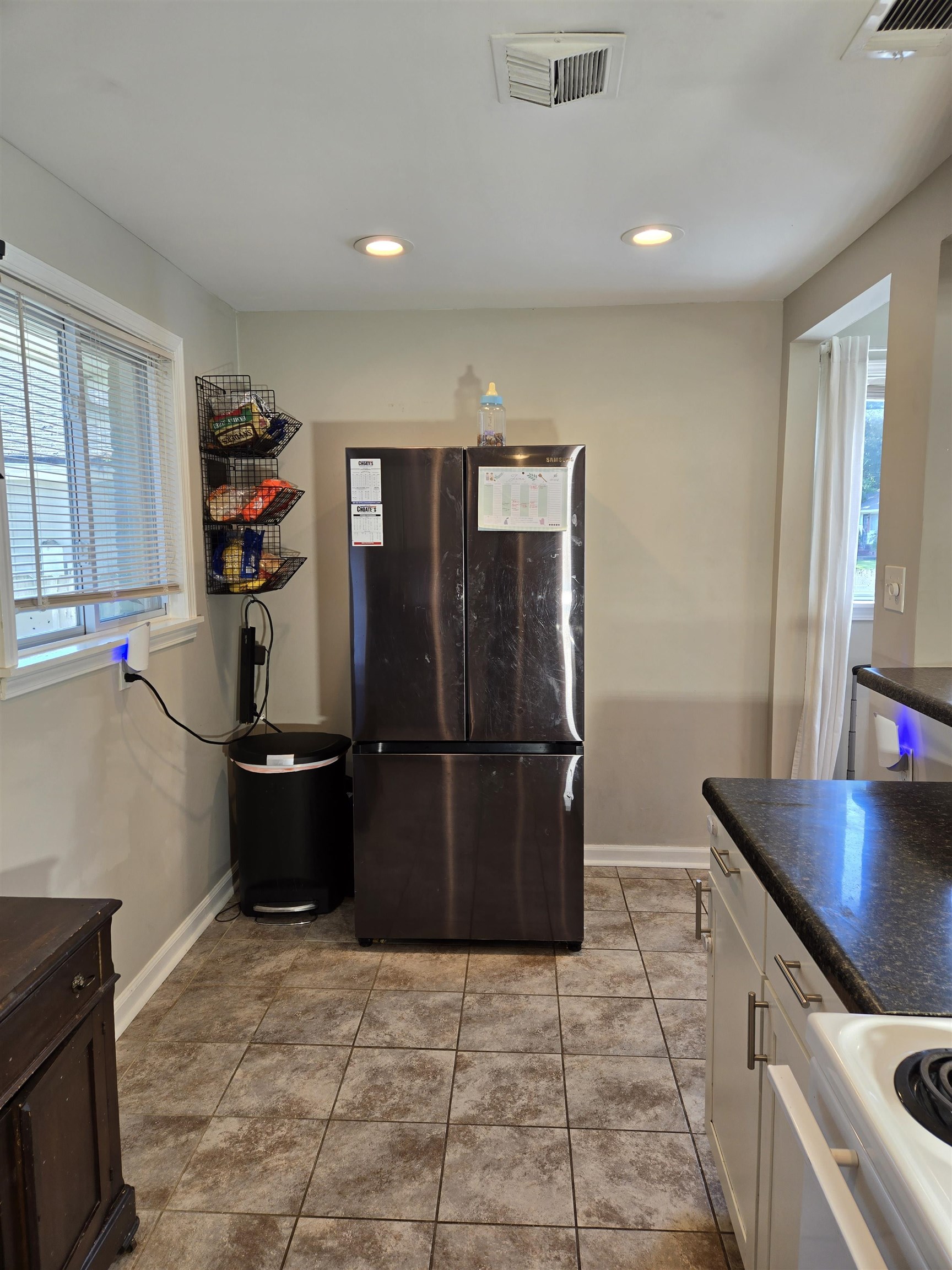 5475 Mesquite Road Memphis, TN 38120 - Photo 8 of 23 a kitchen with a refrigerator and a stove top oven