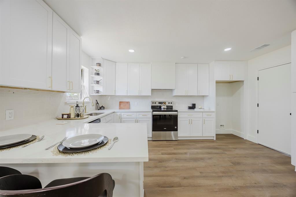2120 Fairfax Road Denton, TX 76205 - Photo 11 of 23 a kitchen with stainless steel appliances a stove a sink and cabinets