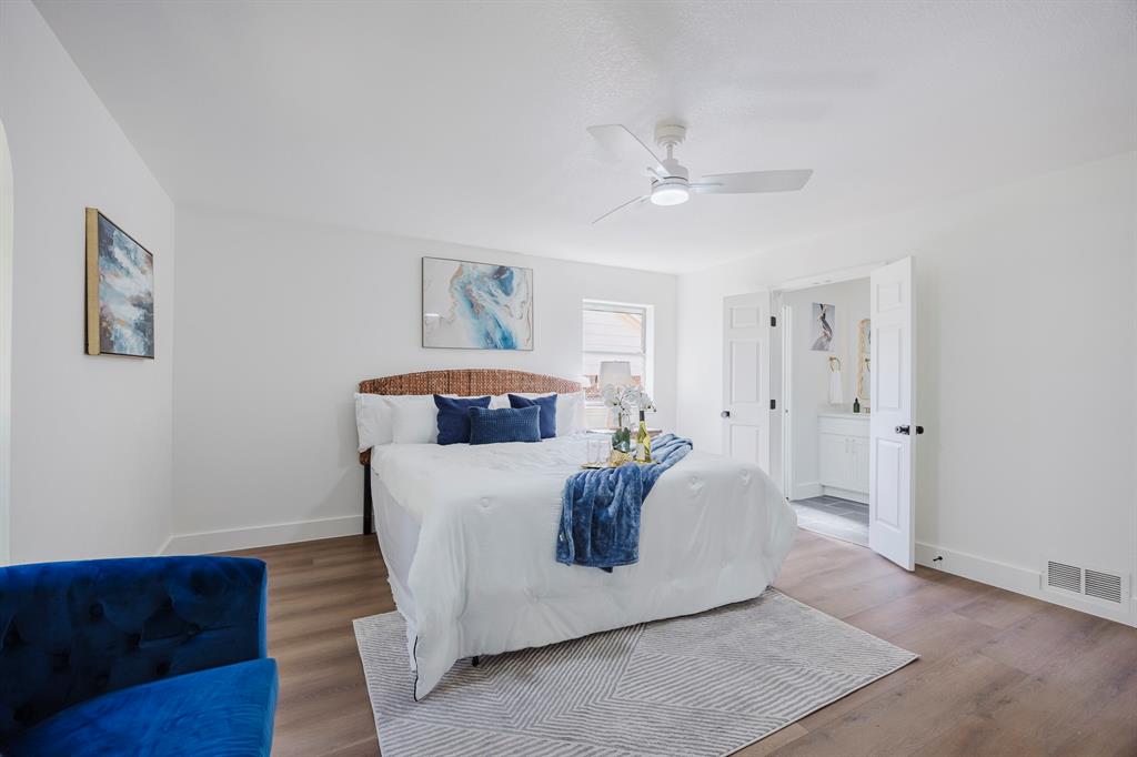 2120 Fairfax Road Denton, TX 76205 - Photo 12 of 23 a bed room with a bed and a chandelier