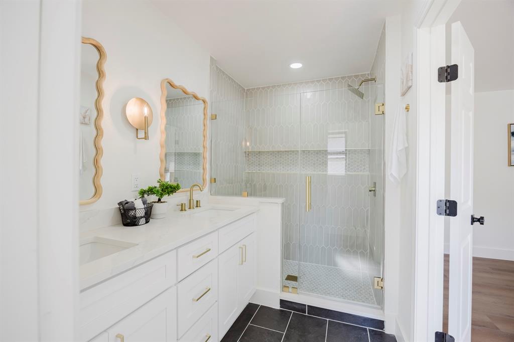 2120 Fairfax Road Denton, TX 76205 - Photo 15 of 23 a bathroom with a granite countertop sink a mirror and shower