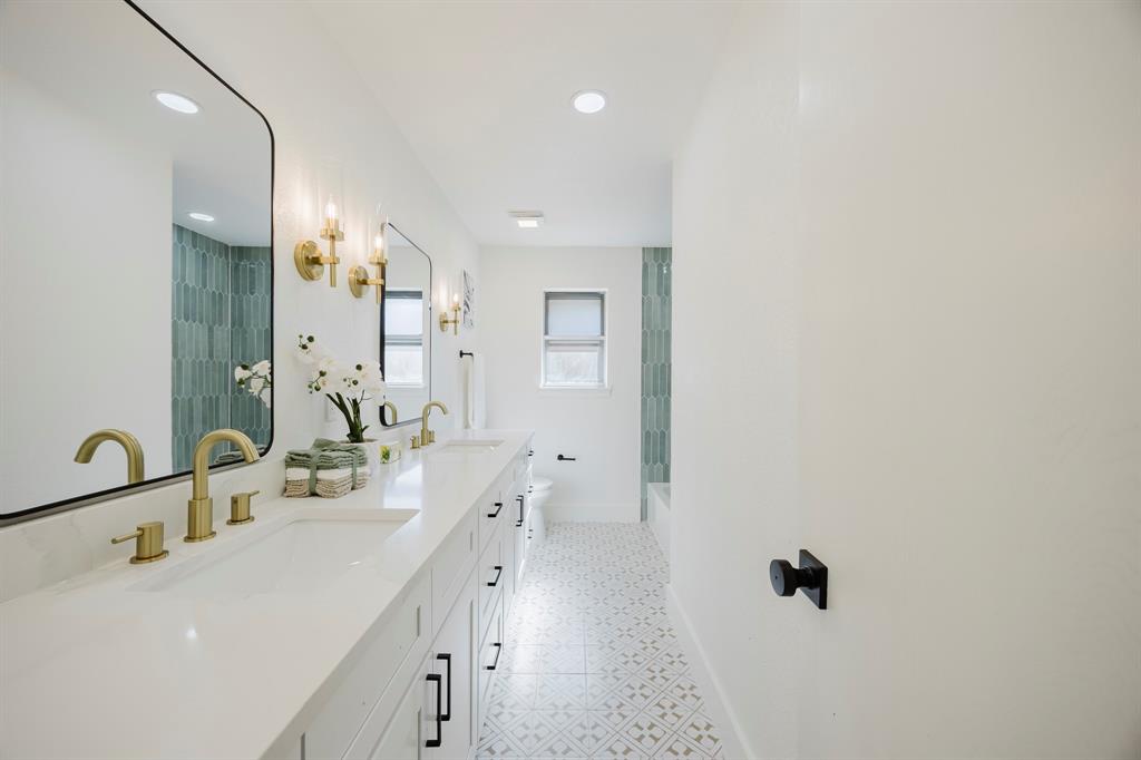 2120 Fairfax Road Denton, TX 76205 - Photo 18 of 23 a bathroom with a double vanity sink a mirror and shower