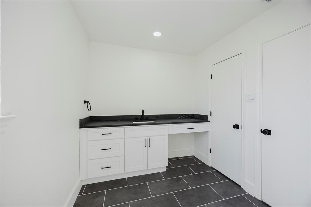 2120 Fairfax Road Denton, TX 76205 - Photo 20 of 23 a room with granite countertop a sink a vanity and a potted plant