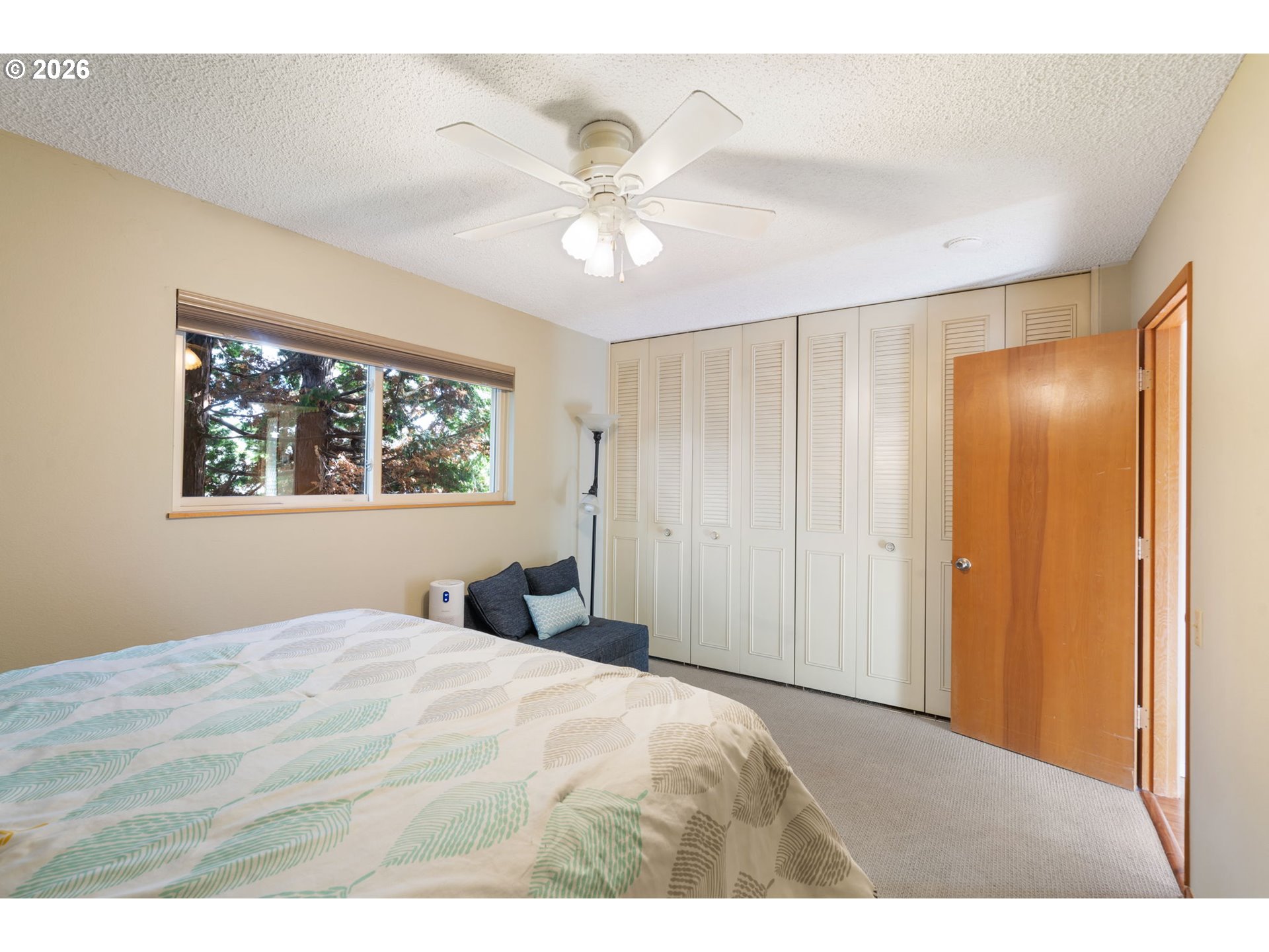 12441 Southwest King George Drive Portland, OR 97224 - Photo 14 of 36 a bedroom with a large bed and a chandelier