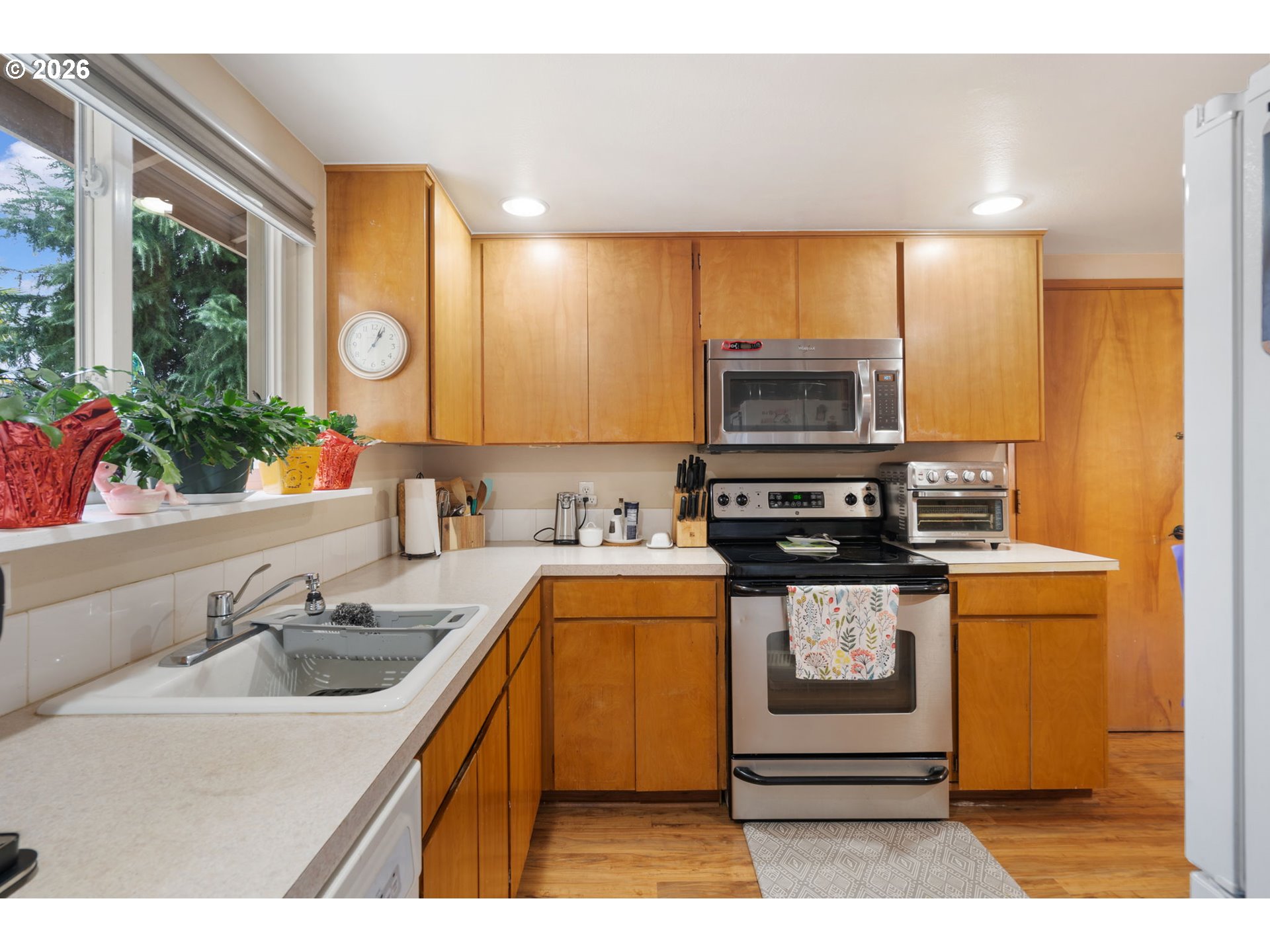 12441 Southwest King George Drive Portland, OR 97224 - Photo 22 of 36 a kitchen with stainless steel appliances granite countertop a stove a sink and a microwave