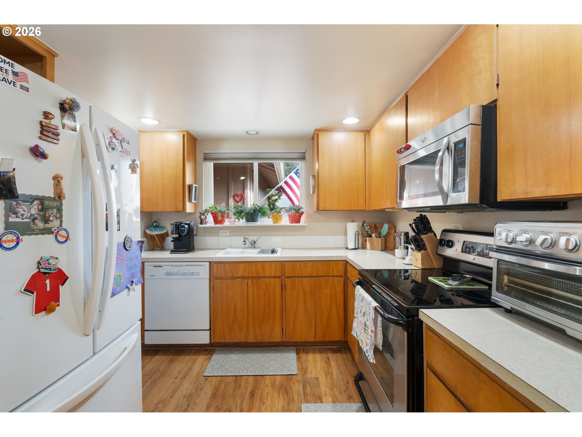 12441 Southwest King George Drive Portland, OR 97224 - Photo 23 of 36 a kitchen with stainless steel appliances granite countertop a sink stove and refrigerator