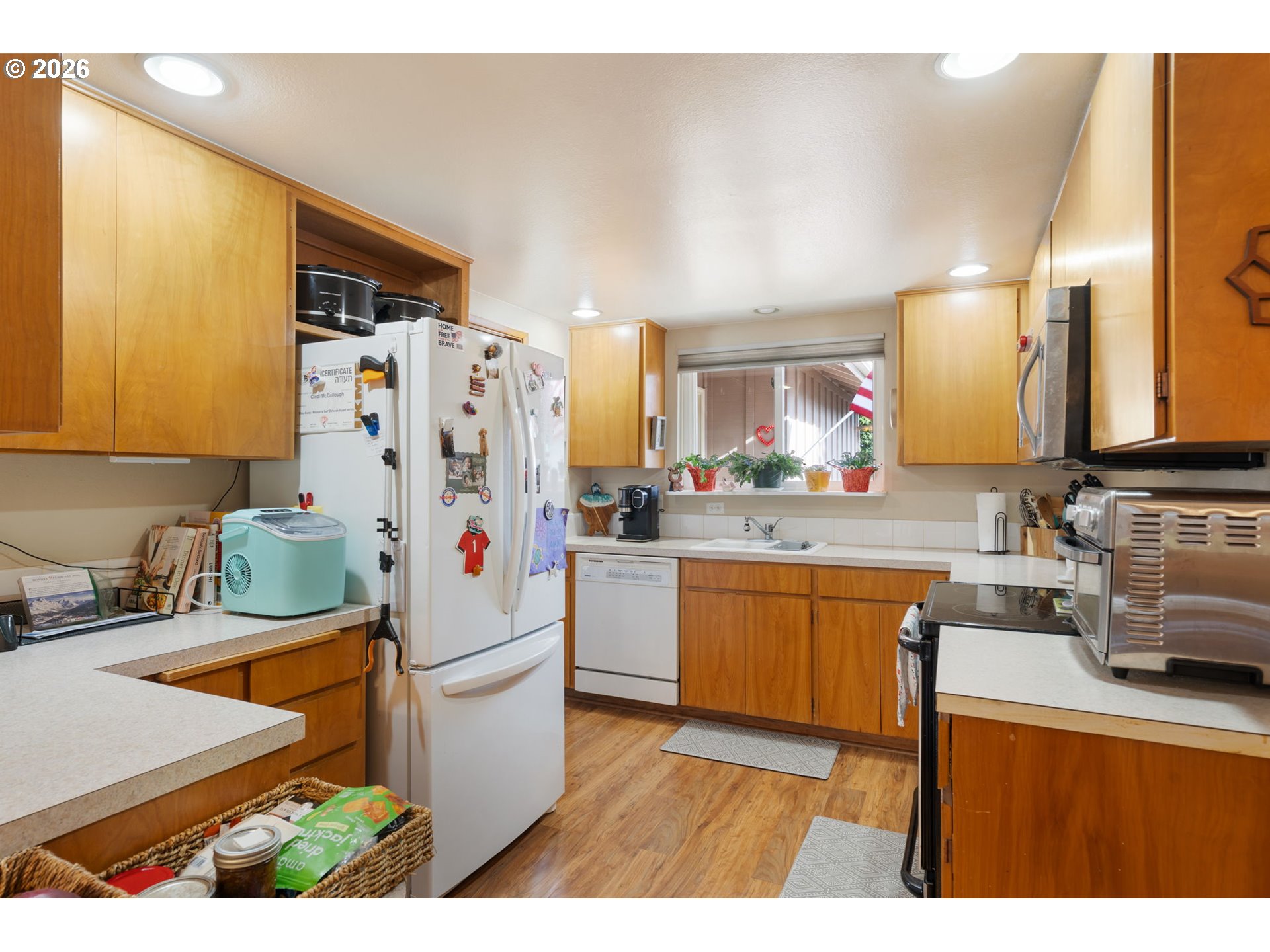 12441 Southwest King George Drive Portland, OR 97224 - Photo 24 of 36 a kitchen with stainless steel appliances a stove a sink cabinets and a refrigerator