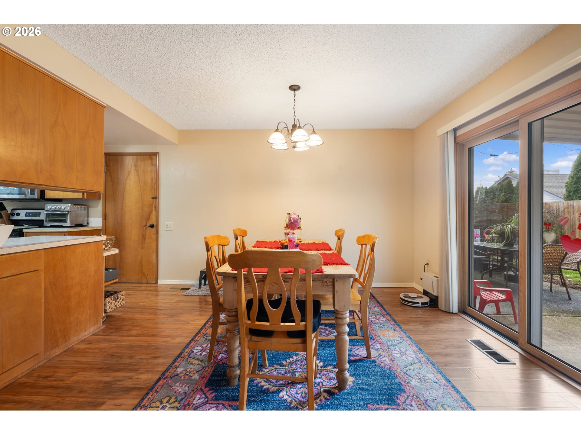 12441 Southwest King George Drive Portland, OR 97224 - Photo 27 of 36 a dining room with furniture a chandelier and wooden floor