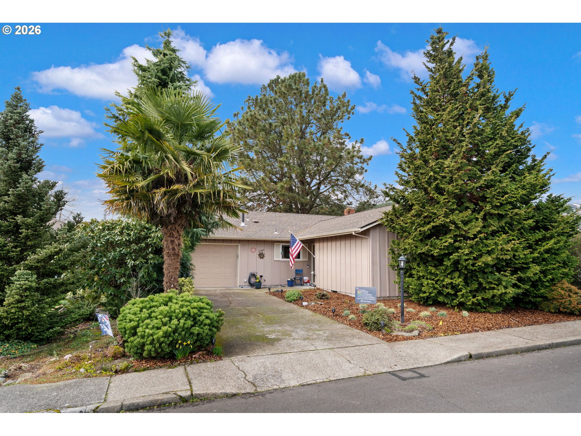 12441 Southwest King George Drive Portland, OR 97224 - Photo 3 of 36 a view of a white house with a yard and plants