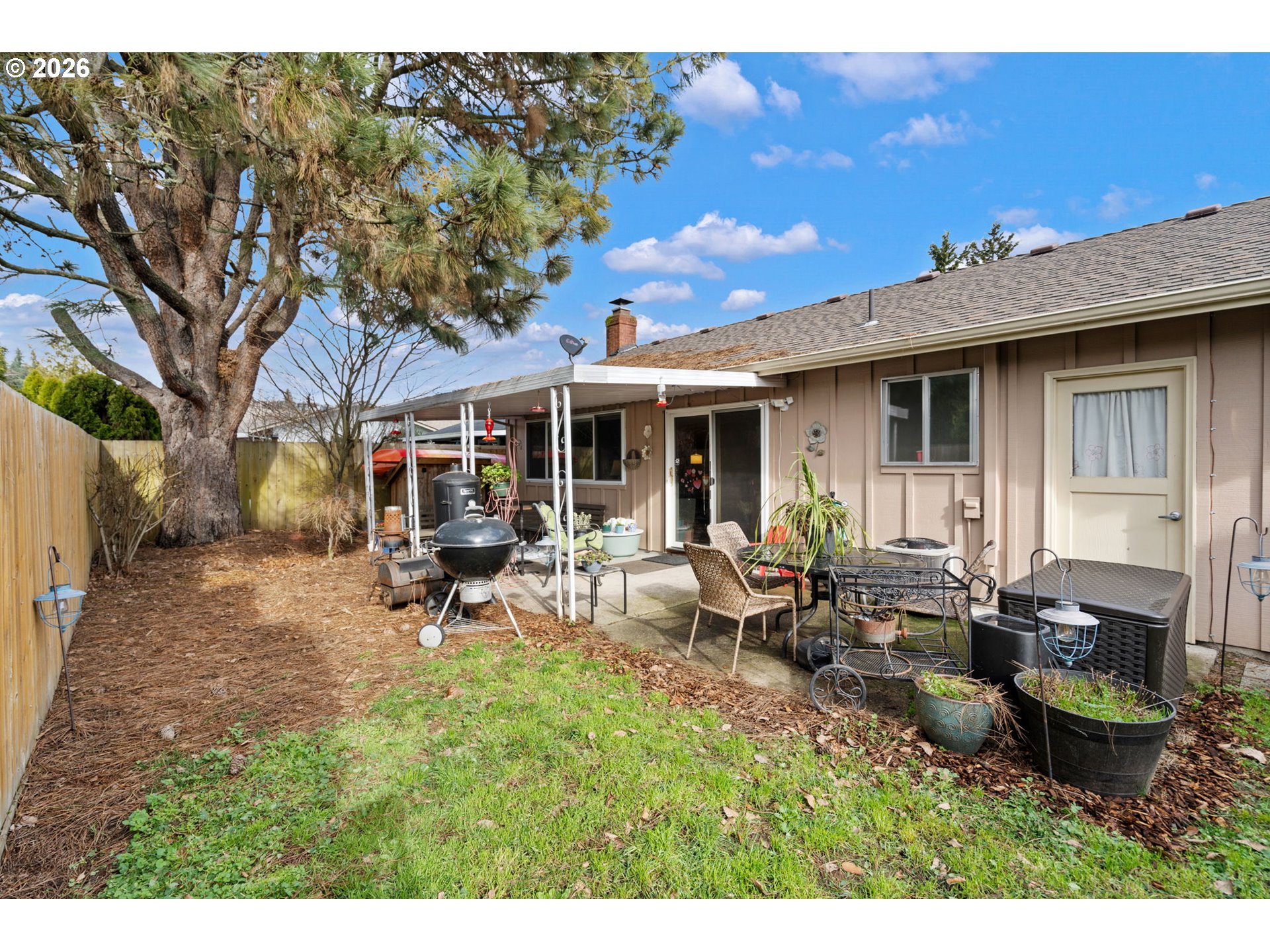 12441 Southwest King George Drive Portland, OR 97224 - Photo 32 of 36 a view of a patio with table and chairs with wooden fence and floor