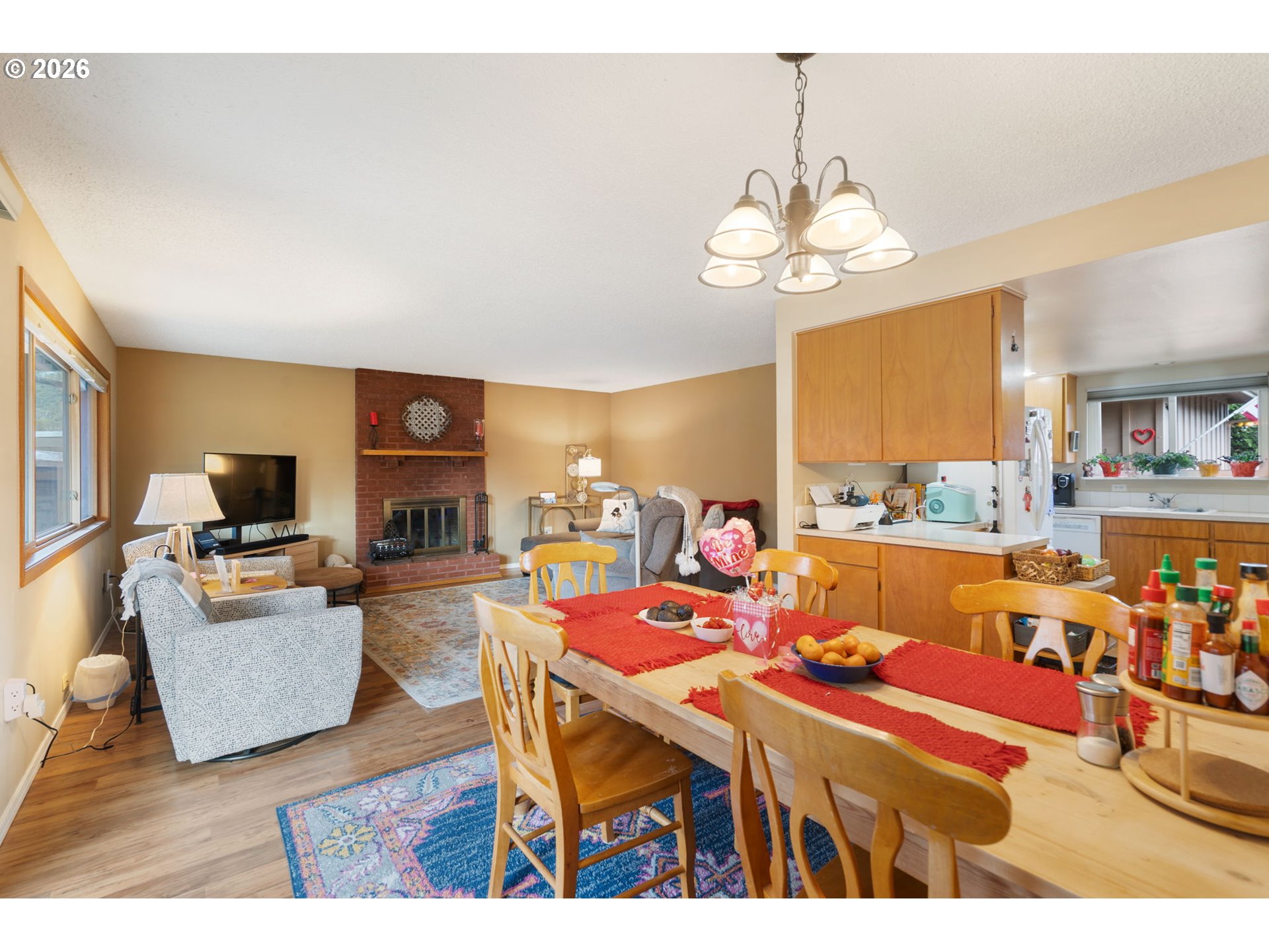 12441 Southwest King George Drive Portland, OR 97224 - Photo 6 of 36 a dining room with wooden floor a chandelier a wooden table and chairs