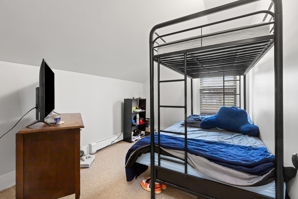 3 Smith Avenue Methuen, MA 01844 - Photo 27 of 38 a bedroom with furniture and a flat screen tv