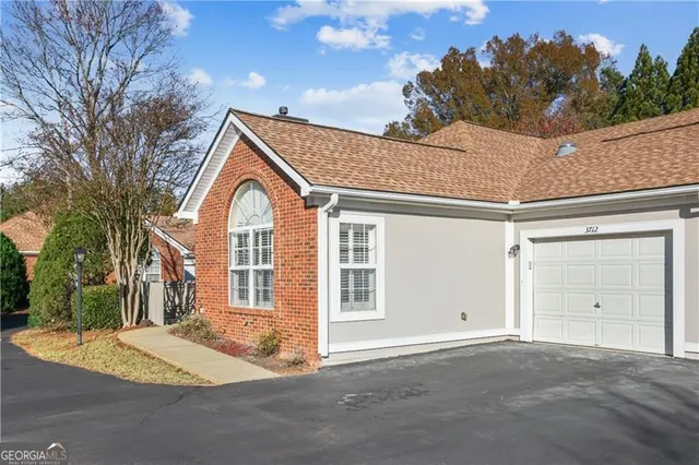 a view of a house with a snow on the road