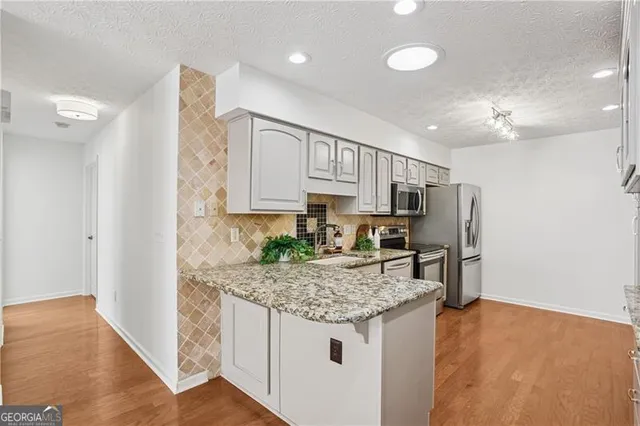 a kitchen with a refrigerator and countertop