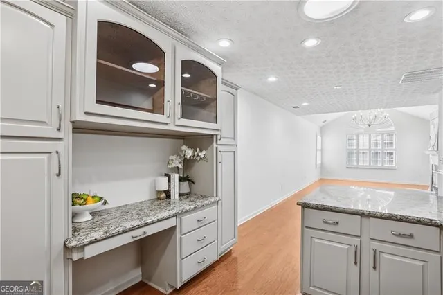 a kitchen with granite countertop cabinets stainless steel appliances and a counter space