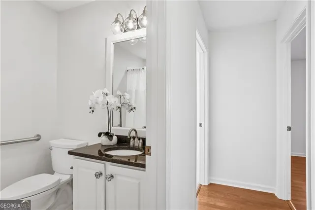 a view of bathroom with a sink mirror and toilet