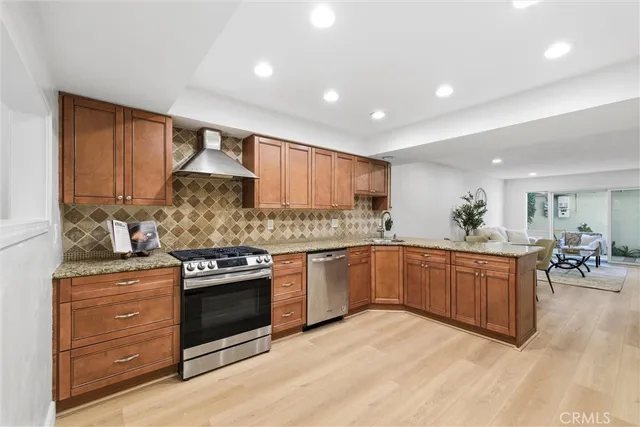 a kitchen with granite countertop kitchen island sink refrigerator and stove