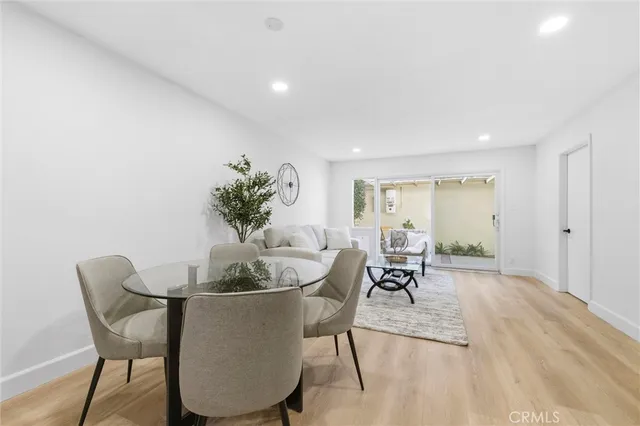 a dining room with furniture and a chandelier