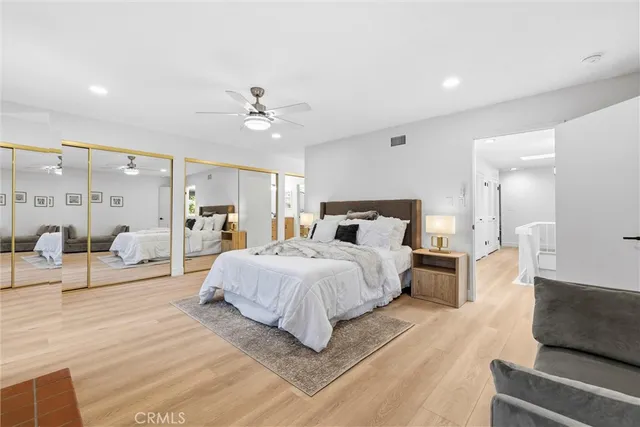 a bedroom with bed and wooden floor