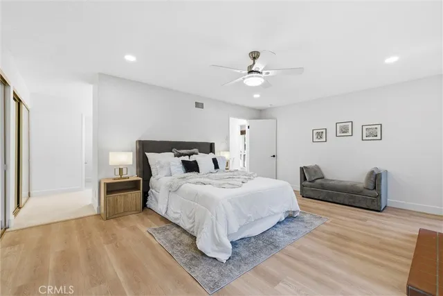 a bedroom with a large bed and a window