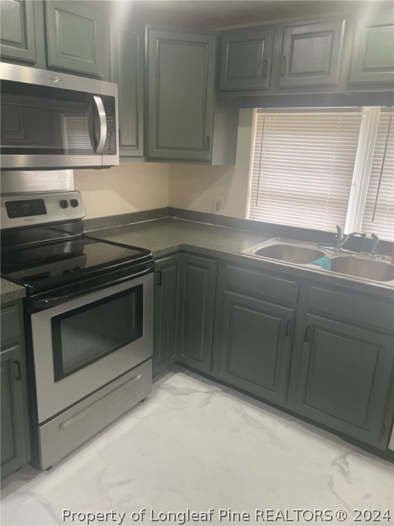 1276 Loop Road Raeford, NC 28376 - Photo 8 of 11 a kitchen with granite countertop a stove microwave and sink
