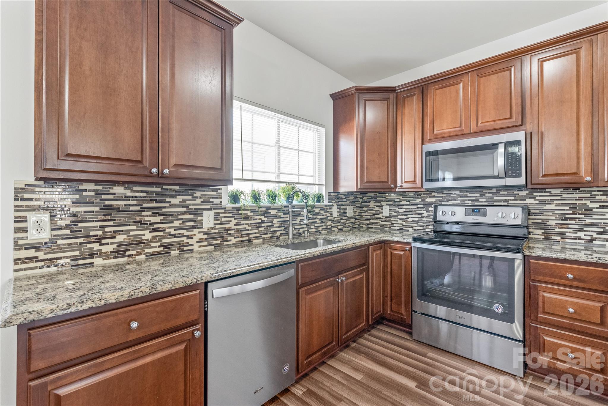1707 Kashmir White Lane Fort Mill, SC 29708 - Photo 7 of 33 a kitchen with stainless steel appliances granite countertop a sink stove and microwave
