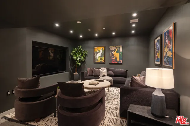 a living room with furniture a lamp and a flat screen tv