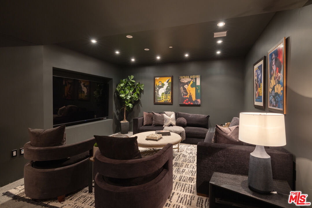 10800 Wilshire Boulevard, Unit 1501 Los Angeles, CA 90024 - Photo 12 of 17 a living room with furniture a lamp and a flat screen tv