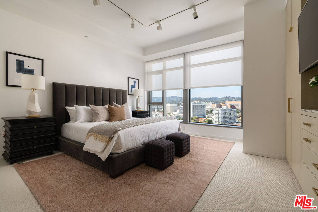 10800 Wilshire Boulevard, Unit 1501 Los Angeles, CA 90024 - Photo 13 of 17 a bed room with a bed and a large window
