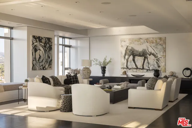 a living room with fireplace furniture and a large window