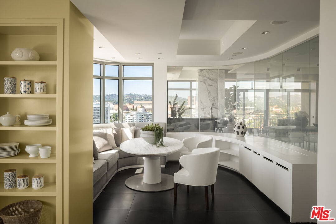 10800 Wilshire Boulevard, Unit 1501 Los Angeles, CA 90024 - Photo 6 of 17 a room with patio furniture and a floor to ceiling window