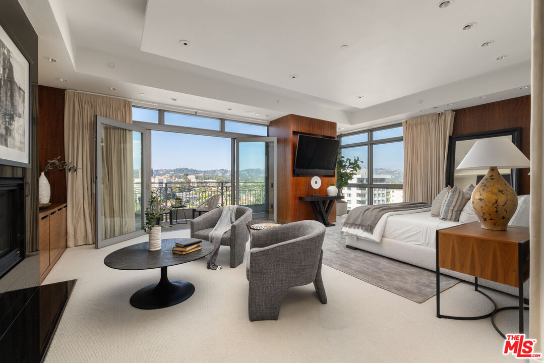 10800 Wilshire Boulevard, Unit 1501 Los Angeles, CA 90024 - Photo 7 of 17 a living room with furniture and a flat screen tv