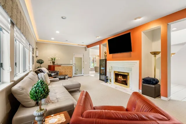 a living room with furniture fireplace and flat screen tv
